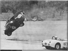 Vaulting end over end, 95 leaves ground as Shulter's car skids backward on dirt.
