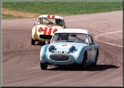 A pair of racing frogeye / bugeye sprites fight for the lead
